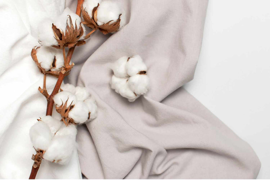 Cotton flowers and fabric on a white background